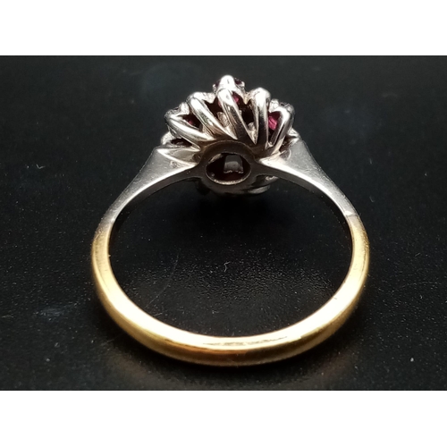 603 - An 18 K white & yellow gold ring with a cluster of rubies and diamonds.