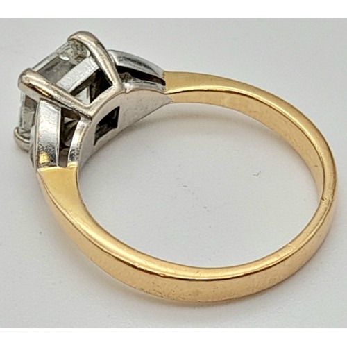 24 - An 18K Yellow Gold Diamond Solitaire Ring. Excellent quality princess cut 2ct centre stone flanked b... 