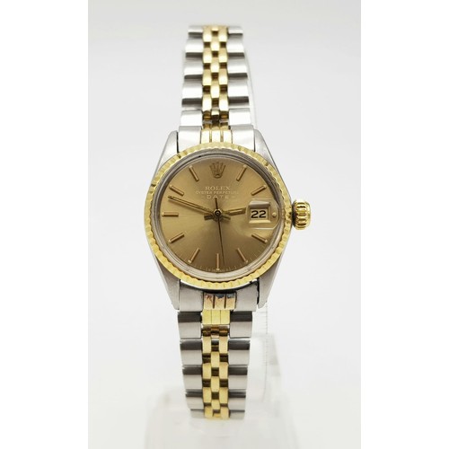 604 - A ROLEX OYSTER PERPETUAL DATE WATCH IN BI-METAL WITH GOLDTONE FACE .  25mm