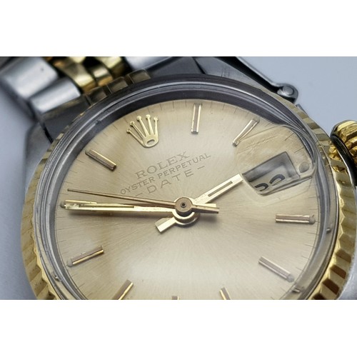 604 - A ROLEX OYSTER PERPETUAL DATE WATCH IN BI-METAL WITH GOLDTONE FACE .  25mm