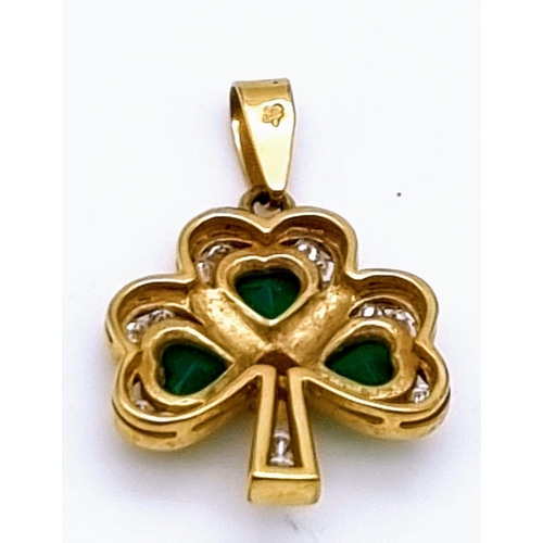 348 - A 9 K yellow gold shamrock pendant with green and white stones. Weight: 2.7 g.