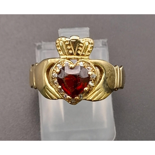 233 - A 9 K yellow gold garnet set Claddagh ring. Size: P, weight: 2.9 g.