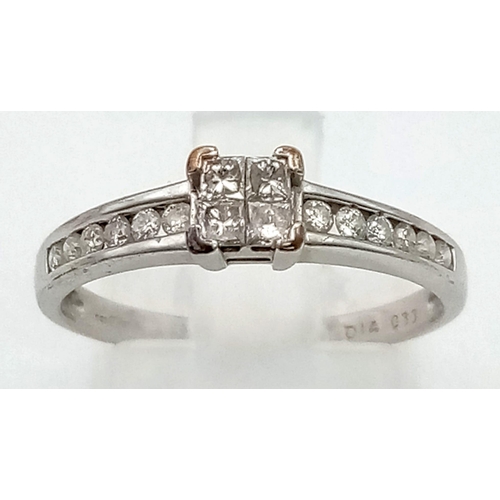 374 - A 9K White Gold Princess-Cut Diamond Ring. Four clean princess-cut central diamonds supported by two... 