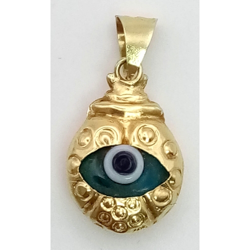 390 - A 14 K yellow gold veil eye pendant. weight: 1 g.