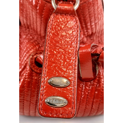 436 - A Chloe Red Shoulder Bag. Red calf leather with silver tone hardware. Two exterior flap pockets with... 