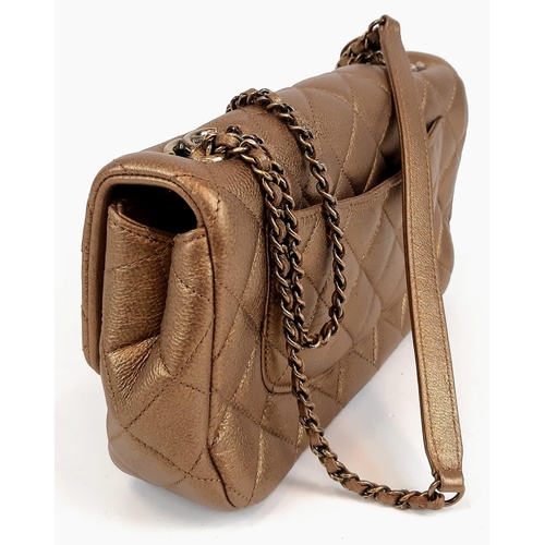 408 - A Gilded Chanel Classic Goatskin Flap Bag. Interwoven chain and leather strap. Gold tone hardware. S... 