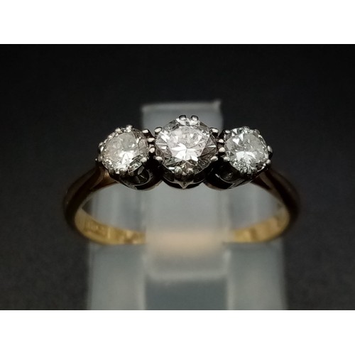 206 - A three stone diamond ring made up of 0.65 carat diamonds set in 18ct yellow gold with a platinum he... 