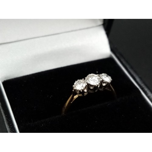 206 - A three stone diamond ring made up of 0.65 carat diamonds set in 18ct yellow gold with a platinum he... 