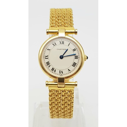 64 - A LADIES 18K GOLD CARTIER WRISTWATCH ON CHAIN STYLE STRAP , ROUND FACE WITH ROMAN NUMERALS.  24mm