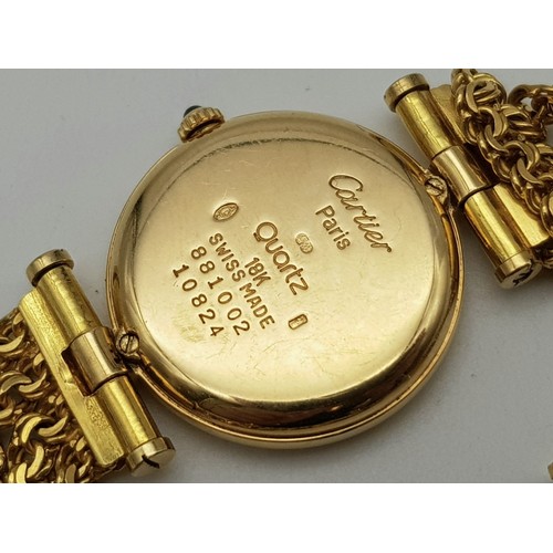 64 - A LADIES 18K GOLD CARTIER WRISTWATCH ON CHAIN STYLE STRAP , ROUND FACE WITH ROMAN NUMERALS.  24mm