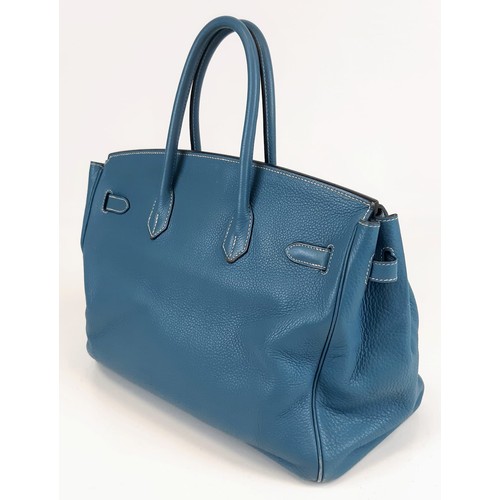 121 - A Hermes Birkin 35 Blue Handbag. Gold tone hardware. Zip and flap pocket interior. 34 x 27cm. In ver... 