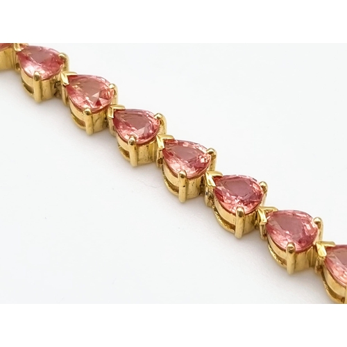 102 - An 18K Yellow Gold Pink Topaz Tennis Bracelet. 31 beautiful clean topaz teardrops create a stunning ... 