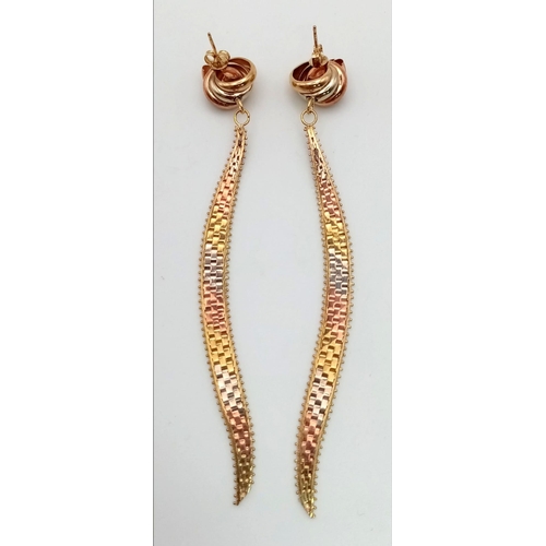 131 - A 9K Three-Colour Gold Pair of Knot and Drop Cleopatra Earrings. 11cm drop. 10.28g total weight.