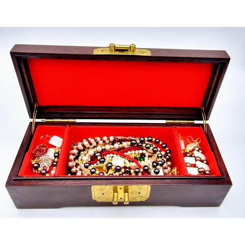 133 - A Vintage, small, Chinese, wooden, jewellery box with a group of genuine, natural pearl necklaces an... 