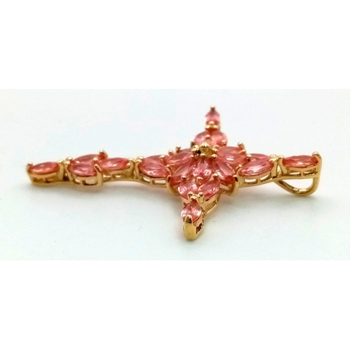 136 - An 18K Yellow Gold Pink Topaz Cross Pendant. 21 clean, pink, oval cut topaz set gemstones give this ... 