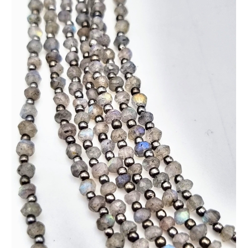 161 - An impressive seven row, multifaceted labradorite (variety blue flash) necklace. Length: 49-52 cm, t... 