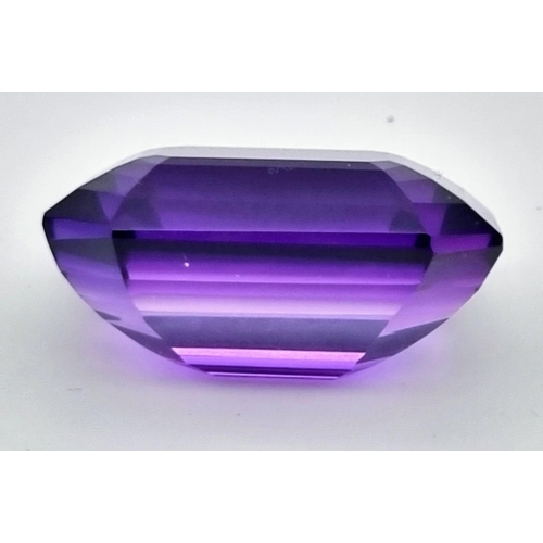 175 - A very collectable, large (76.80 carats) amethyst. Emerald cut with a strong violet colour saturatio... 