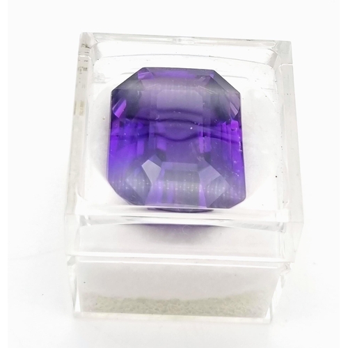 175 - A very collectable, large (76.80 carats) amethyst. Emerald cut with a strong violet colour saturatio... 