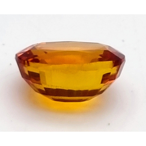 217 - A very desirable, large (25.80 carats) orange sapphire. Cushion cut, flawless, with wonderful colour... 