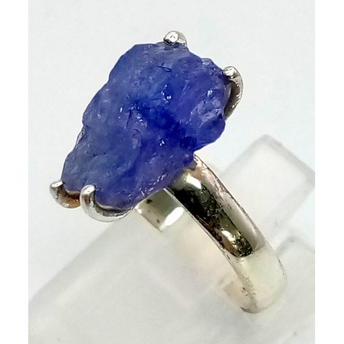 231 - A sterling silver ring with a large, natural, rough, Tanzanite, in a red rose shaped presentation bo... 