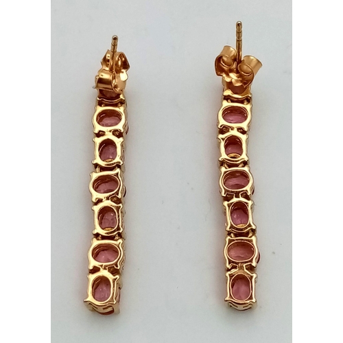 40 - A Pair of 18K Yellow Gold Pink Topaz Drop Earrings. Seven oval cut pink topaz with a 33mm drop. 6.6g... 