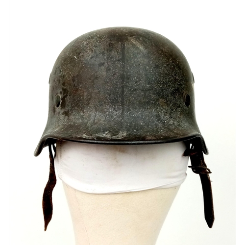 121 - A German WW2 M-40 Luftwaffe Helmet. Single decal still present. Chinstrap named and dated for 1942. ... 