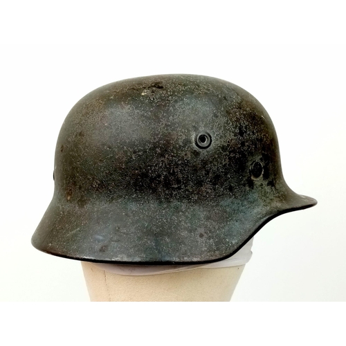 121 - A German WW2 M-40 Luftwaffe Helmet. Single decal still present. Chinstrap named and dated for 1942. ... 