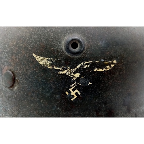 121 - A German WW2 M-40 Luftwaffe Helmet. Single decal still present. Chinstrap named and dated for 1942. ... 