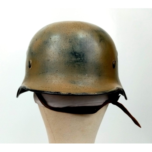 145 - A WW2 German Luftwaffe Helmet with Single Decal. Painted in tropical/Italian paint. Markings on chin... 