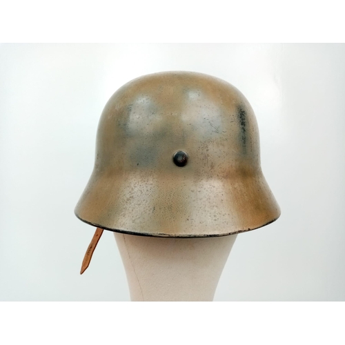 145 - A WW2 German Luftwaffe Helmet with Single Decal. Painted in tropical/Italian paint. Markings on chin... 