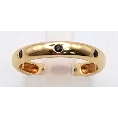 741 - AN 18K GOLD SAPPHIRE AND DIAMOND BAND RING. 3.5gms  size L