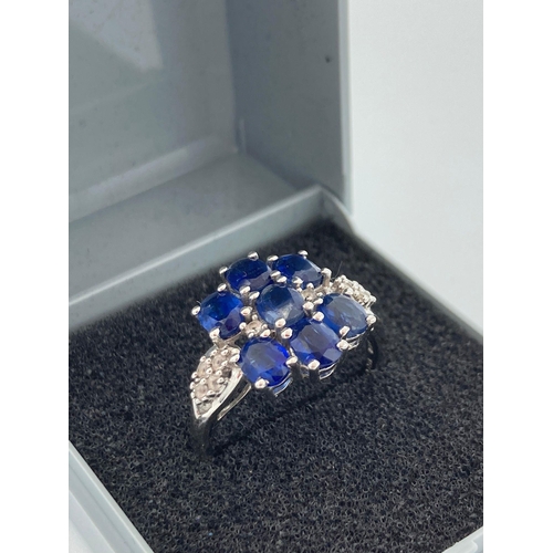 120 - SILVER RING having BLUE and WHITE TOPAZ gemstones  set and mounted to top and shoulders with clear m... 