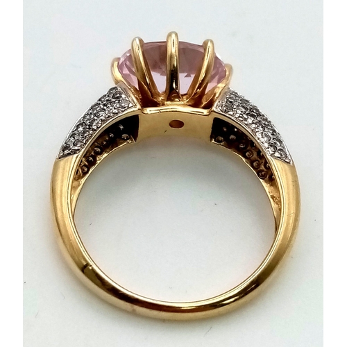 155 - A 14K Yellow Gold Kunzite and Diamond Ring. Oval cut large central kunzite gemstone with baguette di... 