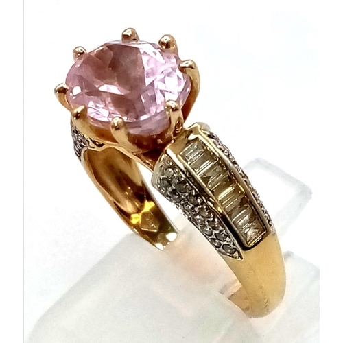 155 - A 14K Yellow Gold Kunzite and Diamond Ring. Oval cut large central kunzite gemstone with baguette di... 