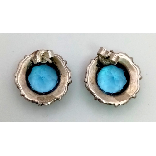 208 - A Hypnotising Blue Gemstone Jewellery Suite. Comprising of earrings and two brooches set in silver. ... 