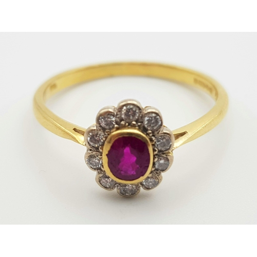 243 - An 18K Edwardian Yellow Gold and Platinum Top, Ruby and Diamond Ring. Central natural oval ruby surr... 