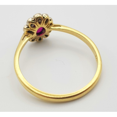 243 - An 18K Edwardian Yellow Gold and Platinum Top, Ruby and Diamond Ring. Central natural oval ruby surr... 