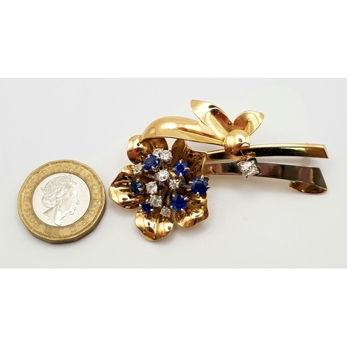 26 - AN 18K YELLOW AND WHITE GOLD DIAMOND AND SAPPHIRE BROOCH IN FLORAL DESIGN.  19gms  0.60ct