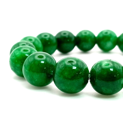 734 - A Green Jade Bead Expandable Bracelet. 12mm beads