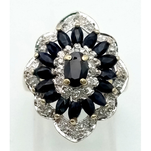 184 - AN IMPRESSIVE 9K YELLOW GOLD DIAMOND & SAPPHIRE CLIUSTER RING IN FLOWER SHAPE, WEIGHT 5.1G SIZE K