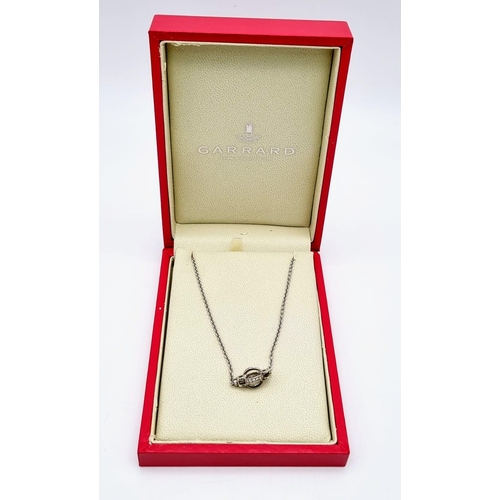 78 - An Italian Made 18K White Gold Garrad Diamond Pendant - On an 18K white gold necklace. Two diamond c... 