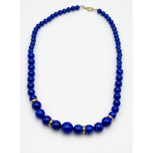 71 - A Lapis Lazuli Graduated Collarette Necklace with a 9K Yellow Gold Clasp and Spacer Beads. 41.54g to... 