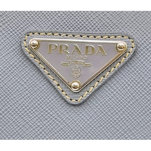 219 - A Prada Pale Blue Leather Mini Tote Bag. Prada log on exterior. Monogram cloth interior with zip poc... 