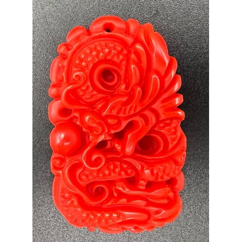 1265 - A Red Jade Dragon Pendant. 6cm