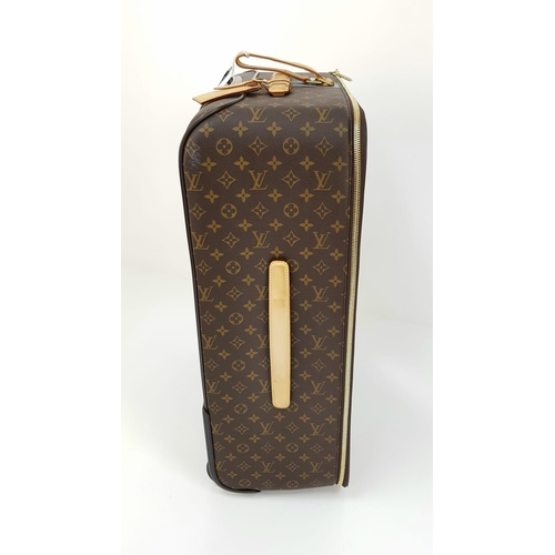 25 - A Louis Vuitton Monogram Suitcase. Brown canvas with leather handle and gilded hardware. On wheels w... 