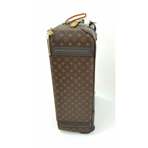 25 - A Louis Vuitton Monogram Suitcase. Brown canvas with leather handle and gilded hardware. On wheels w... 