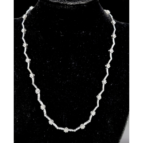 53 - An 18K White Gold and Diamond Set Collar Necklace. 0.60ct.
20.3g total weight. 42cm