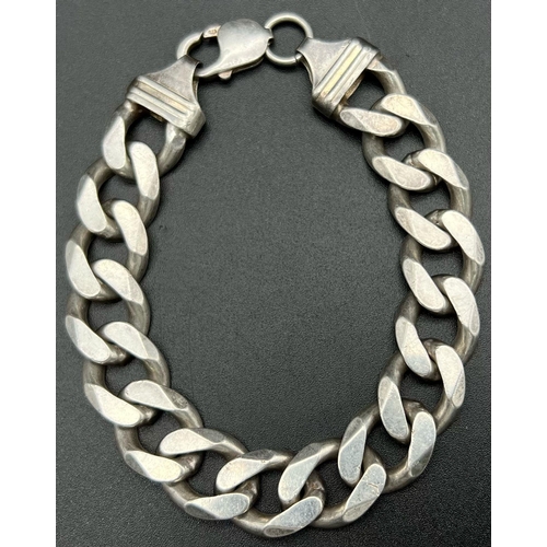 738 - A Heavy Sterling Silver Curb Link Bracelet. 68g. 20cm