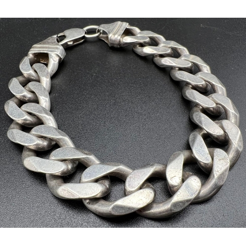 738 - A Heavy Sterling Silver Curb Link Bracelet. 68g. 20cm