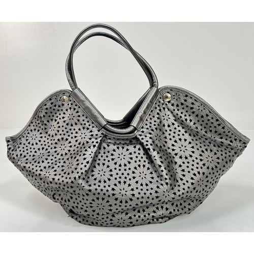 198 - A Jimmy Choo Star Perforated Leather Tote Bag. Silver and black exterior. One interior open and one ... 